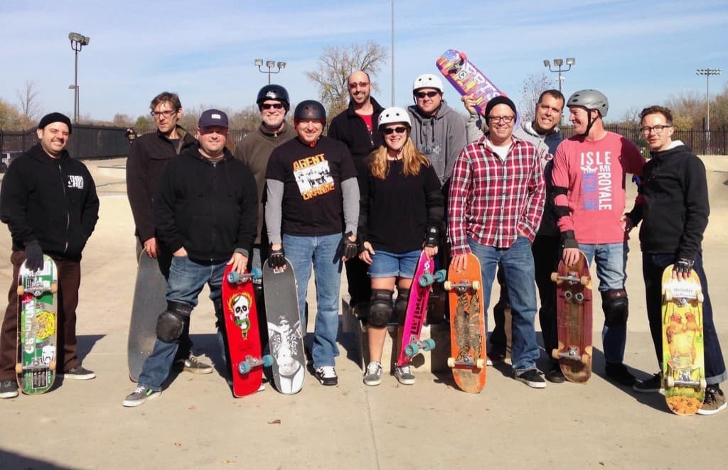 Group of skateboarders posing together at a community skatepark session